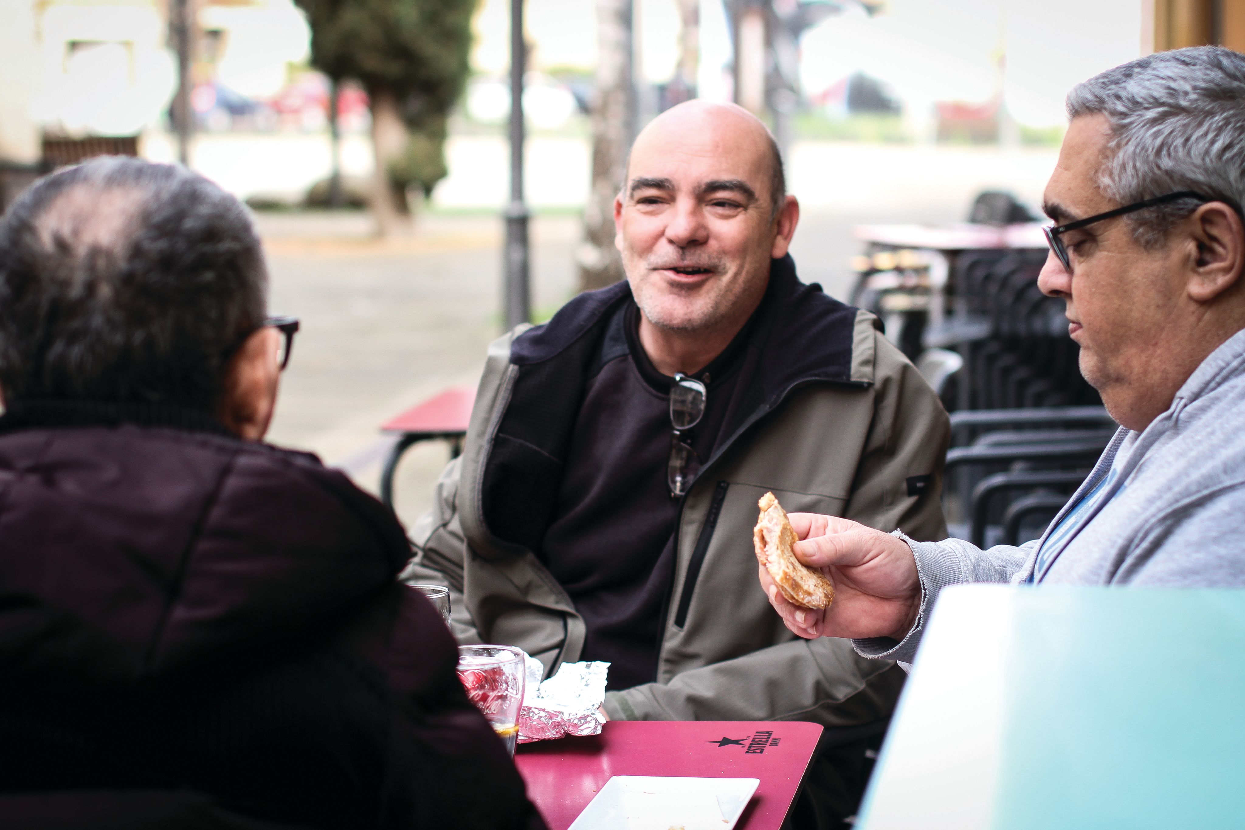 A woman with glasses smiling in a room